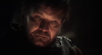 Movie still from “Henry V” (1989), directed by Kenneth Branagh – A person wearing a black shirt; Close Up shot, Low angle