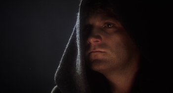 Movie still from “Henry V” (1989), directed by Kenneth Branagh – A person wearing a hooded sweatshirt; Close Up shot, Low angle