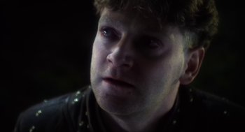 Movie still from “Henry V” (1989), directed by Kenneth Branagh – A person wearing a leather jacket; Close Up shot, Over the shoulder angle