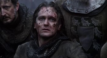 Movie still from “Henry V” (1989), directed by Kenneth Branagh – A person wearing a costume; Close Up shot, Low angle