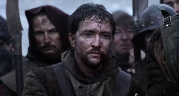 Movie still from “Henry V” (1989), directed by Kenneth Branagh – A group of men standing next to each other in the snow; Close Up shot, Low angle