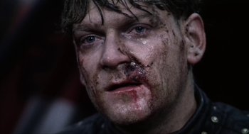 Movie still from “Henry V” (1989), directed by Kenneth Branagh – A person with blood all over his face; Close Up shot, Low angle