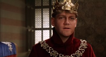 Movie still from “Henry V” (1989), directed by Kenneth Branagh – A man wearing a gold crown and a red robe; Close Up shot, Low angle