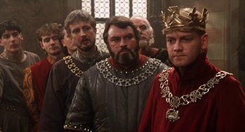 Movie still from “Henry V” (1989), directed by Kenneth Branagh – A group of men standing next to each other; Close Up shot, Over the shoulder angle