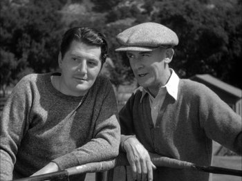 Movie still from “Here Comes Mr. Jordan” (1941), directed by Alexander Hall – An older man and a younger man sitting next to each other; Medium shot, High angle