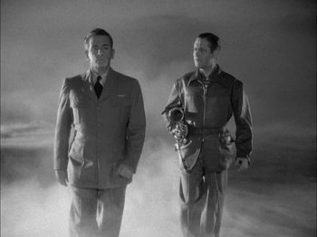 Movie still from “Here Comes Mr. Jordan” (1941), directed by Alexander Hall – Two men standing next to each other on a foggy day; Medium shot, Low angle