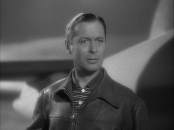 Movie still from “Here Comes Mr. Jordan” (1941), directed by Alexander Hall – A man wearing a leather jacket looking to his left; Close Up shot, Low angle