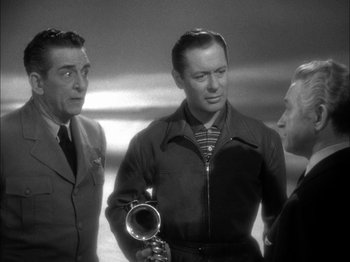Movie still from “Here Comes Mr. Jordan” (1941), directed by Alexander Hall – A group of men standing next to each other in a room; Medium shot, High angle