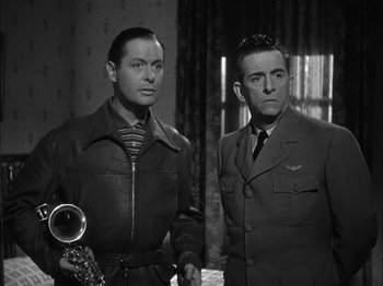 Movie still from “Here Comes Mr. Jordan” (1941), directed by Alexander Hall – A black and white photo of two men standing next to each other; Medium shot, Low angle