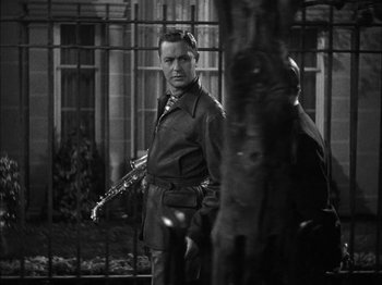 Movie still from “Here Comes Mr. Jordan” (1941), directed by Alexander Hall – A black and white photo of a man holding a saxophone; Medium shot, Low angle