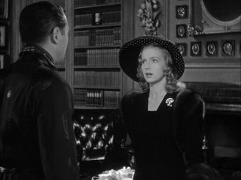 Movie still from “Here Comes Mr. Jordan” (1941), directed by Alexander Hall – A man and a woman talking in a room; Medium shot, Over the shoulder angle