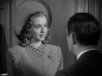 Movie still from “Here Comes Mr. Jordan” (1941), directed by Alexander Hall – An old photo of a man and a woman; Close Up shot, Over the shoulder angle