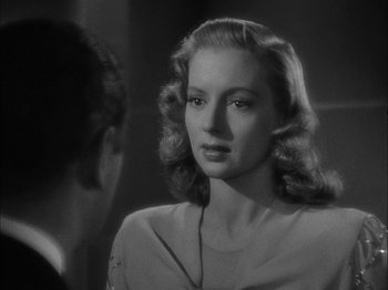 Movie still from “Here Comes Mr. Jordan” (1941), directed by Alexander Hall – A black - and - white photo of a woman in a white dress; Close Up shot, Over the shoulder angle