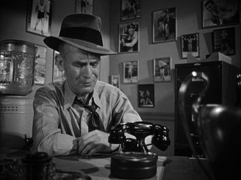 Movie still from “Here Comes Mr. Jordan” (1941), directed by Alexander Hall – An older man sitting at a table with a telephone; Close Up shot, High angle