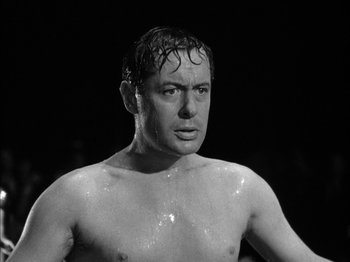 Movie still from “Here Comes Mr. Jordan” (1941), directed by Alexander Hall – Black and white photograph of a shirtless man with wet hair; Close Up shot, Low angle