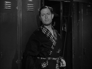 Movie still from “Here Comes Mr. Jordan” (1941), directed by Alexander Hall – A black and white photo of a man wearing a robe; Medium shot, Low angle