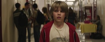 Movie still from “Hesher” (2010), directed by Spencer Susser – A young boy in a white shirt and a red jacket; Close Up shot, Over the shoulder angle
