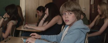 Movie still from “Hesher” (2010), directed by Spencer Susser – A young boy sitting in front of a computer keyboard; Close Up shot, Over the shoulder angle