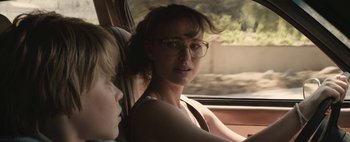Movie still from “Hesher” (2010), directed by Spencer Susser – A woman sitting in the back seat of a car; Close Up shot, Over the shoulder angle