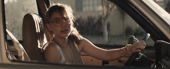 Movie still from “Hesher” (2010), directed by Spencer Susser – A woman driving in a car wearing glasses; Close Up shot, Over the shoulder angle