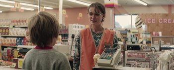 Movie still from “Hesher” (2010), directed by Spencer Susser – A woman in an orange vest holding an ice cream cone; Medium shot, Over the shoulder angle