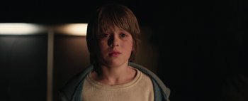 Movie still from “Hesher” (2010), directed by Spencer Susser – A young boy is looking into the camera; Close Up shot, Over the shoulder angle