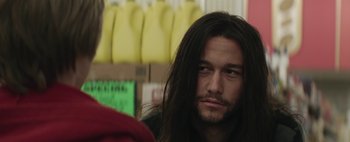 Movie still from “Hesher” (2010), directed by Spencer Susser – A person with long black hair; Close Up shot, Over the shoulder angle