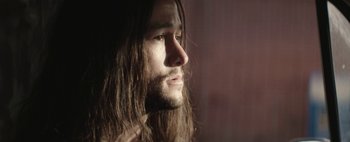 Movie still from “Hesher” (2010), directed by Spencer Susser – A person with long hair; Close Up shot, Low angle