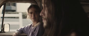 Movie still from “Hesher” (2010), directed by Spencer Susser – A woman and a man are looking out a window; Close Up shot, Over the shoulder angle
