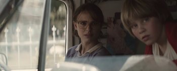 Movie still from “Hesher” (2010), directed by Spencer Susser – A woman wearing glasses looking out of a car window; Close Up shot, Over the shoulder angle