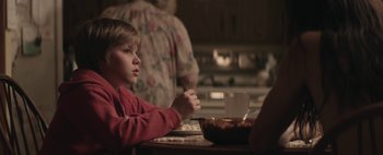 Movie still from “Hesher” (2010), directed by Spencer Susser – A young boy sitting at a table eating cereal; Medium shot, Over the shoulder angle