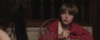Movie still from “Hesher” (2010), directed by Spencer Susser – A boy sitting at a table with a glass of juice; Close Up shot, Over the shoulder angle