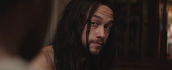 Movie still from “Hesher” (2010), directed by Spencer Susser – A person with long black hair; Close Up shot, Over the shoulder angle