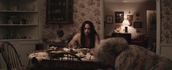 Movie still from “Hesher” (2010), directed by Spencer Susser – A man sitting at a table with a bowl of food; Medium shot, High angle