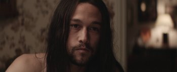 Movie still from “Hesher” (2010), directed by Spencer Susser – A person with long black hair; Close Up shot, Over the shoulder angle