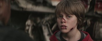 Movie still from “Hesher” (2010), directed by Spencer Susser – A young boy with blood on his face; Close Up shot, Over the shoulder angle