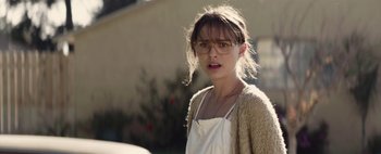 Movie still from “Hesher” (2010), directed by Spencer Susser – A young woman wearing glasses and a sweater; Close Up shot, Over the shoulder angle