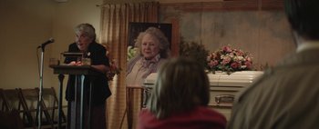 Movie still from “Hesher” (2010), directed by Spencer Susser – A woman standing in front of a mirror in front of a casket; Medium shot, Over the shoulder angle