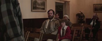 Movie still from “Hesher” (2010), directed by Spencer Susser – A man and a boy sitting in a church; Medium shot, Over the shoulder angle