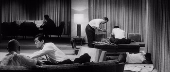 Movie still from “High and Low” (1963), directed by Akira Kurosawa – A group of people sitting in a living room; Wide shot, Low angle
