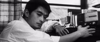 Movie still from “High and Low” (1963), directed by Akira Kurosawa – Black and white photograph of a man writing on a paper; Close Up shot, Low angle