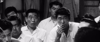 Movie still from “High and Low” (1963), directed by Akira Kurosawa – Three asian men in white shirts smoking cigarettes; Close Up shot, High angle