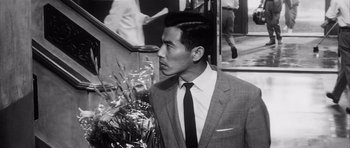 Movie still from “High and Low” (1963), directed by Akira Kurosawa – Black and white photograph of a man in a suit and tie; Close Up shot, High angle