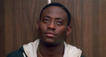 Movie still from “Higher Learning” (1995), directed by John Singleton – A person wearing a white shirt; Close Up shot, Low angle