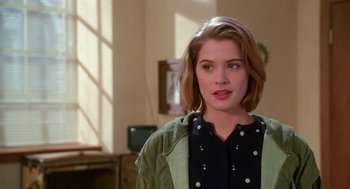 Movie still from “Higher Learning” (1995), directed by John Singleton – A young woman with short brown hair wearing a green jacket; Close Up shot, Over the shoulder angle