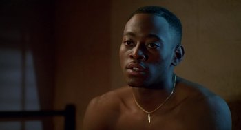 Movie still from “Higher Learning” (1995), directed by John Singleton – A person wearing a necklace; Close Up shot, Over the shoulder angle