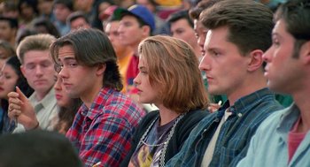 Movie still from “Higher Learning” (1995), directed by John Singleton – A group of young people sitting in a crowd; Medium shot, High angle