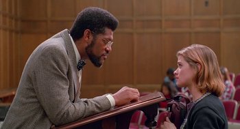 Movie still from “Higher Learning” (1995), directed by John Singleton – A man and a woman talking in front of a judge; Medium shot, Over the shoulder angle