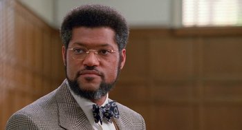 Movie still from “Higher Learning” (1995), directed by John Singleton – A person wearing a suit and a bow tie; Close Up shot, Low angle