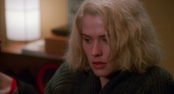 Movie still from “Higher Learning” (1995), directed by John Singleton – A woman with blonde hair sitting in front of a window; Close Up shot, High angle